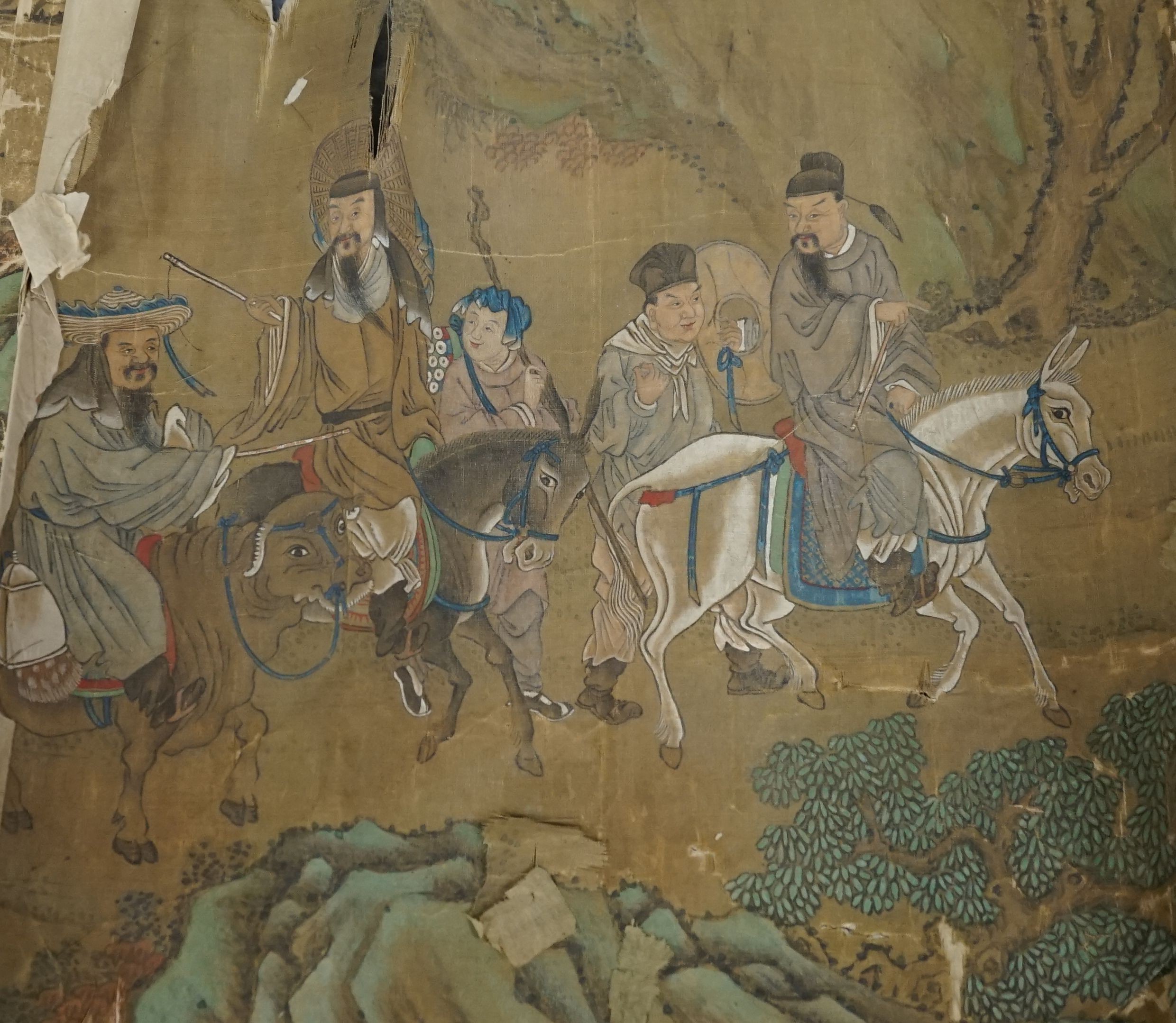 A 19th century Chinese hand scroll painting on silk of figures in a landscape, approximately 206 cm X 32.5 cm